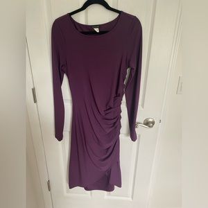 Side ruched, stretchy dress. Front has a cross cross bottom.